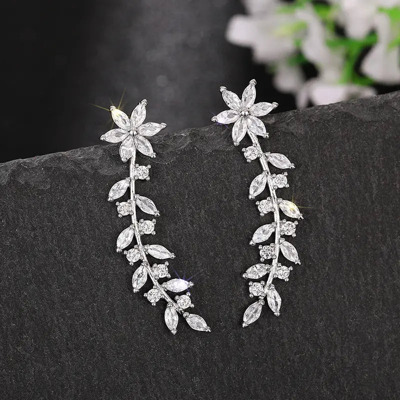 Silver leaf-shaped drop earrings adorned with clear faceted crystals from the crystal floral vine ear climber earrings for women collection.