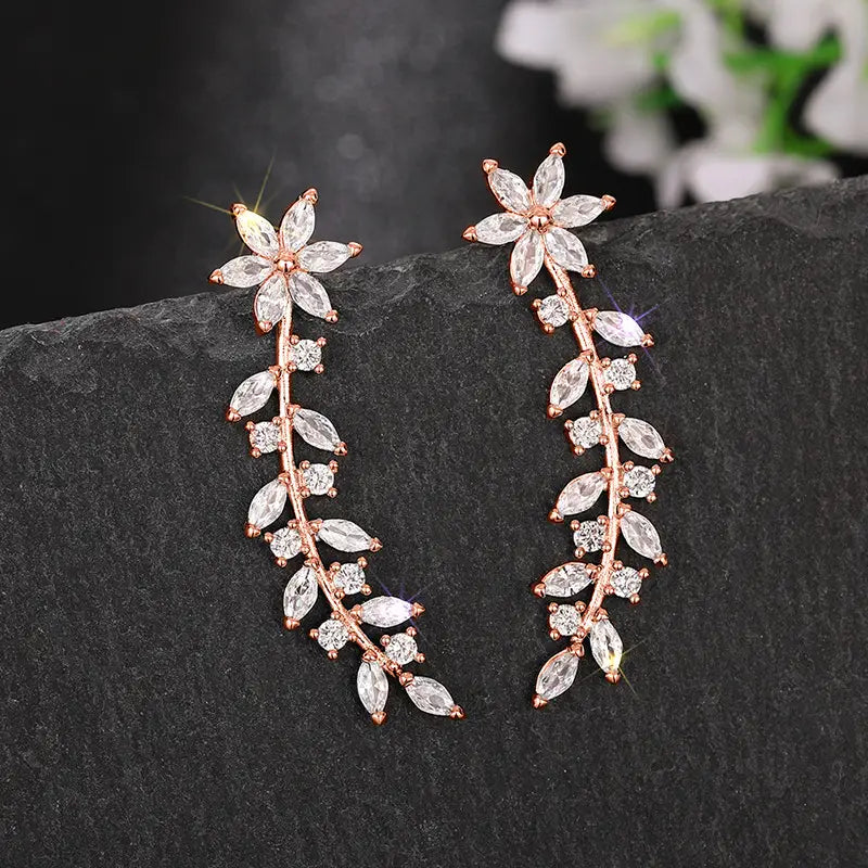rose gold vine-shaped drop earrings adorned with clear marquise and round-cut crystals from the crystal floral vine ear climber earrings collection for women
