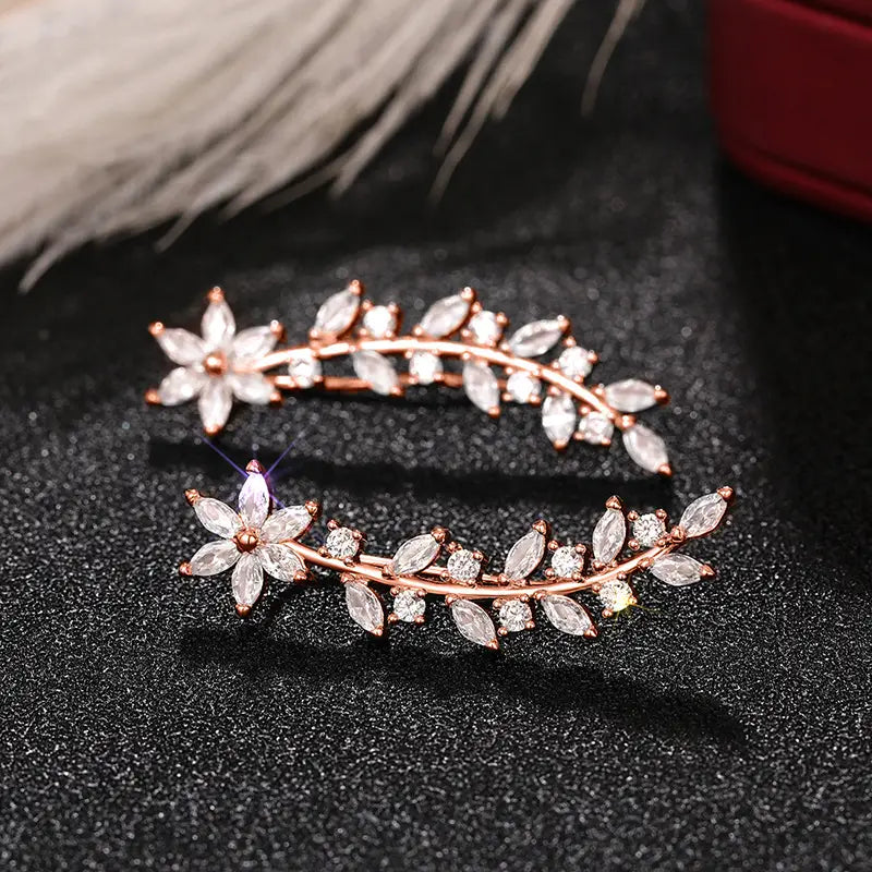 Rose gold-toned crystal floral vine ear climber earrings for women featuring clear faceted crystals in a delicate leaf and flower design.