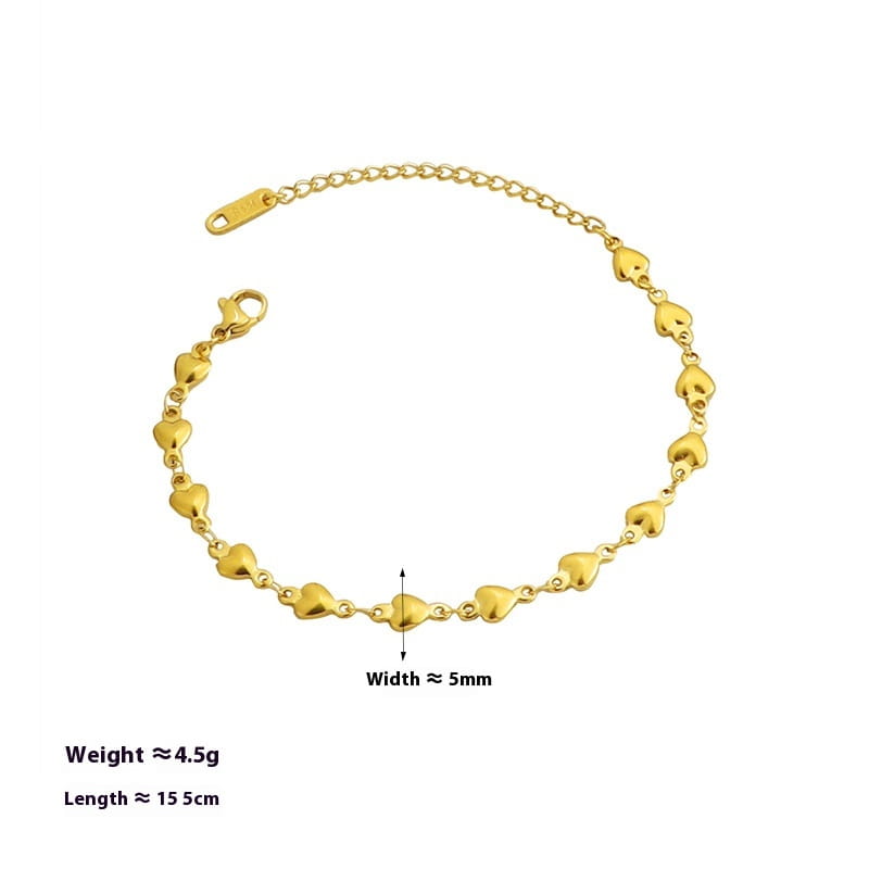 Gold-toned heart-shaped link anklet with clasp closure made of polished titanium steel.