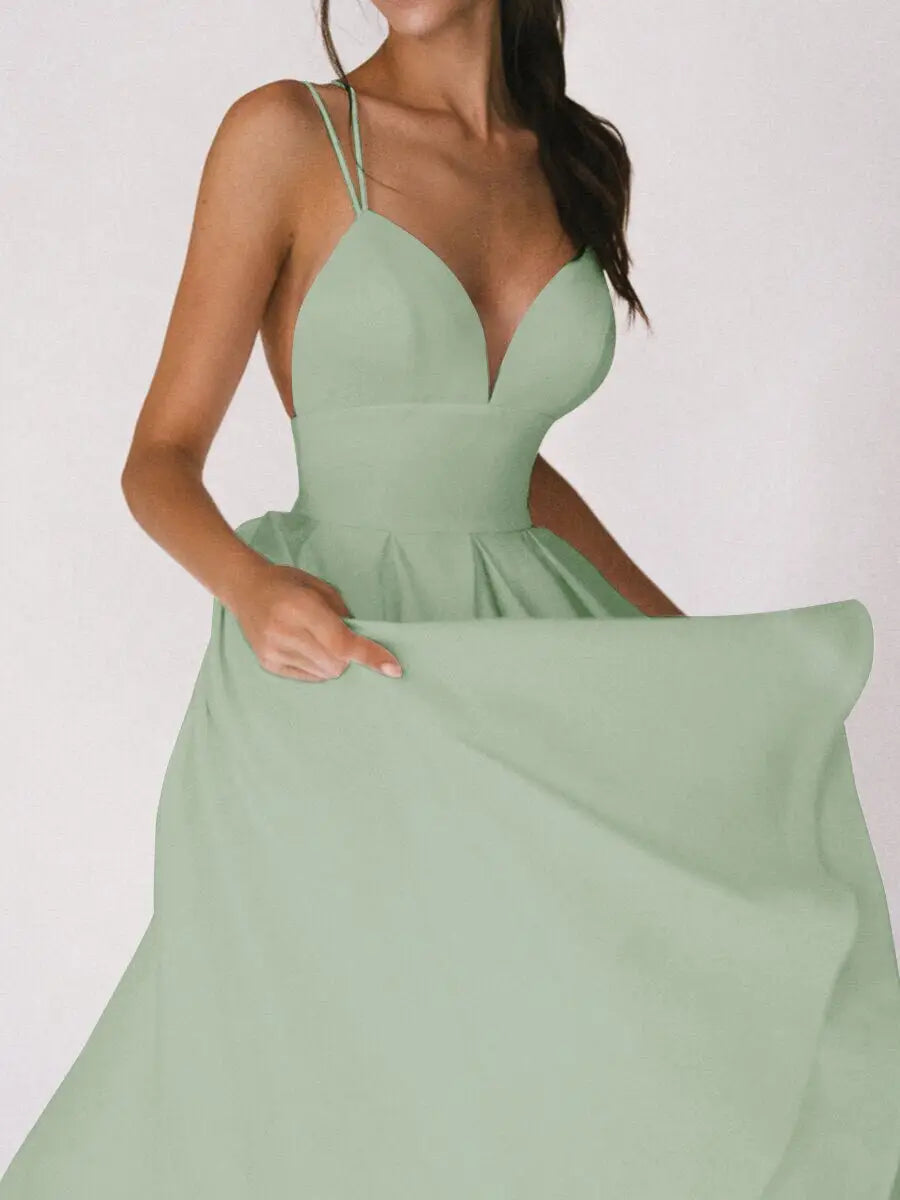 A flowing mint green satin a line midi dress with a deep v neckline and delicate spaghetti straps.