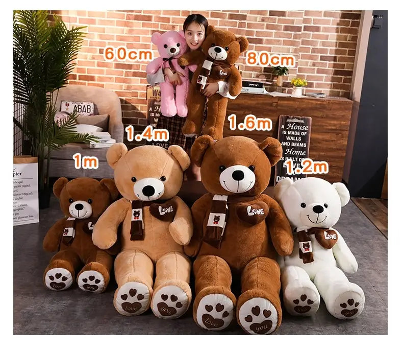 A plush teddy bear soft stuffed animal doll with soft brown fur white paws and snout wearing a dark brown scarf embroidered with the word love in gold thread measuring 60 to 100 cm.