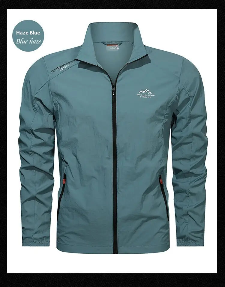 Men’s ultrathin sun protective sports jacket in haze blue lightweight fabric with a subtle mountain logo and red zipper pulls.
