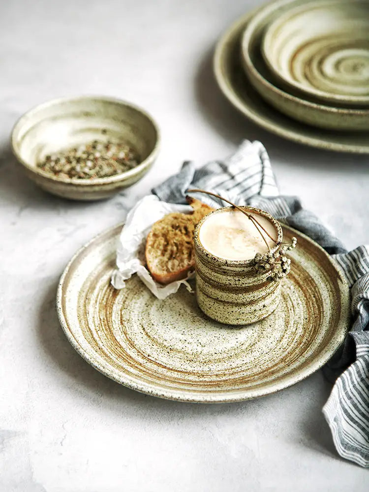 Rustic ceramic coffee cup with concentric brown and beige stripes and speckled glaze finish from the ceramic rustic speckled stoneware tableware set.