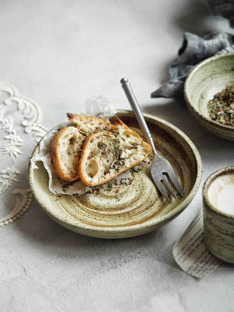Earthenware bowl from ceramic rustic speckled stoneware tableware set with a matte finish and subtle concentric rings.