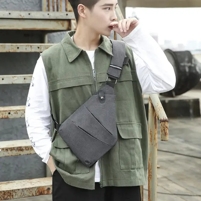 Dark gray canvas men’s waterproof anti-theft multifunctional crossbody bag with multiple pockets and adjustable strap.