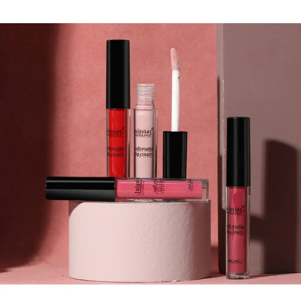 a collection of four julystar soft matte lip cream nonstick liquid lipsticks in clear glass tubes with black caps featuring red pink and nude shades in 2ml size