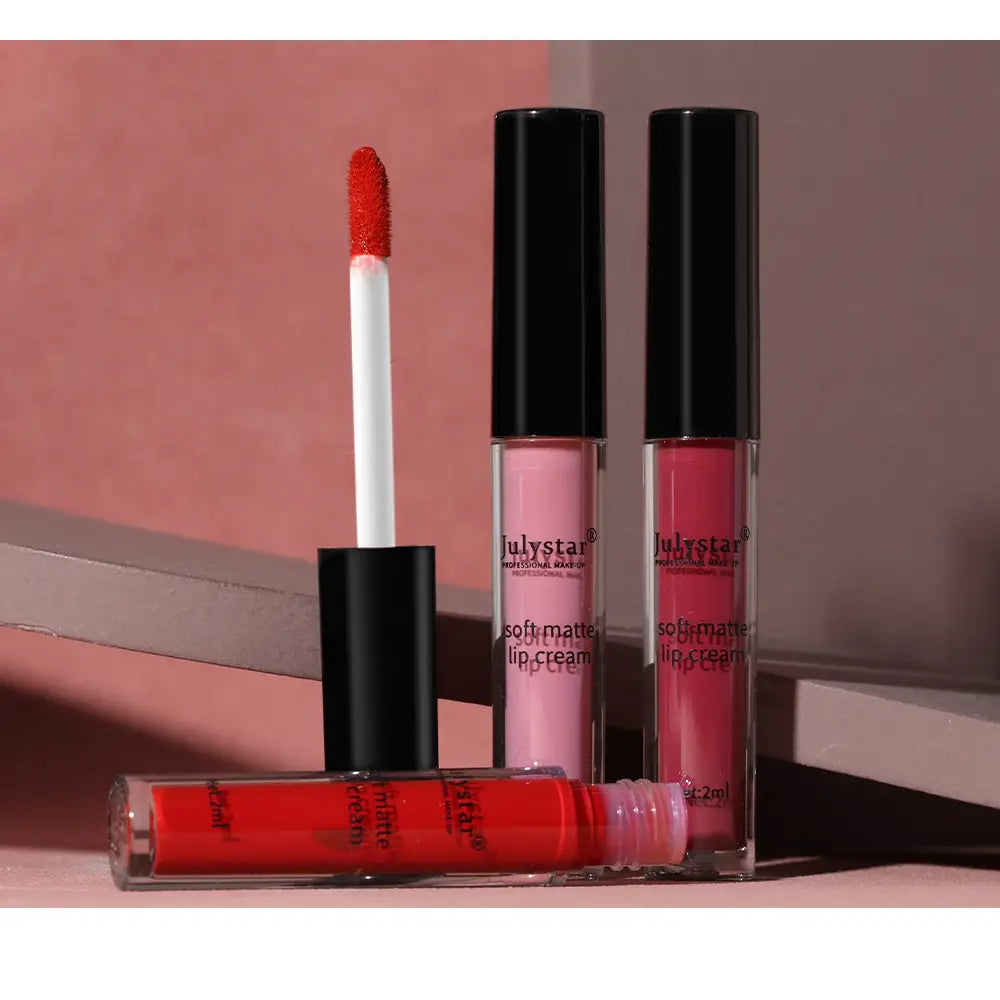 three transparent tubes of julystar soft matte lip cream in pink and red shades with black caps and white applicators for nonstick liquid lipstick 2ml.