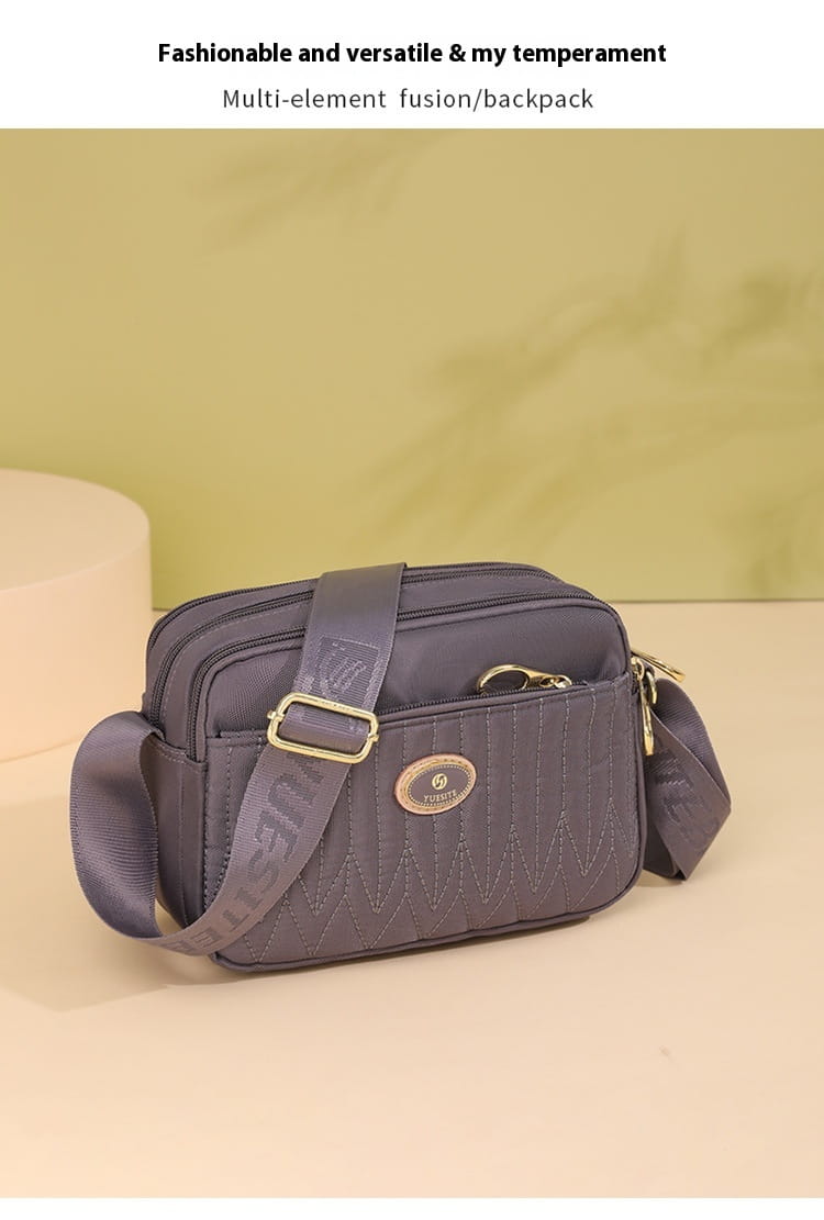 Dark gray multi-element fusion backpack with quilted texture and gold-tone hardware accents featured as a quilted crossbody bag with gold hardware and strap.