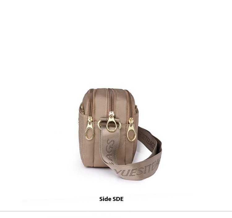 Beige nylon quilted crossbody bag with gold hardware, gold-tone zippers, and a matching strap featuring embossed branding.