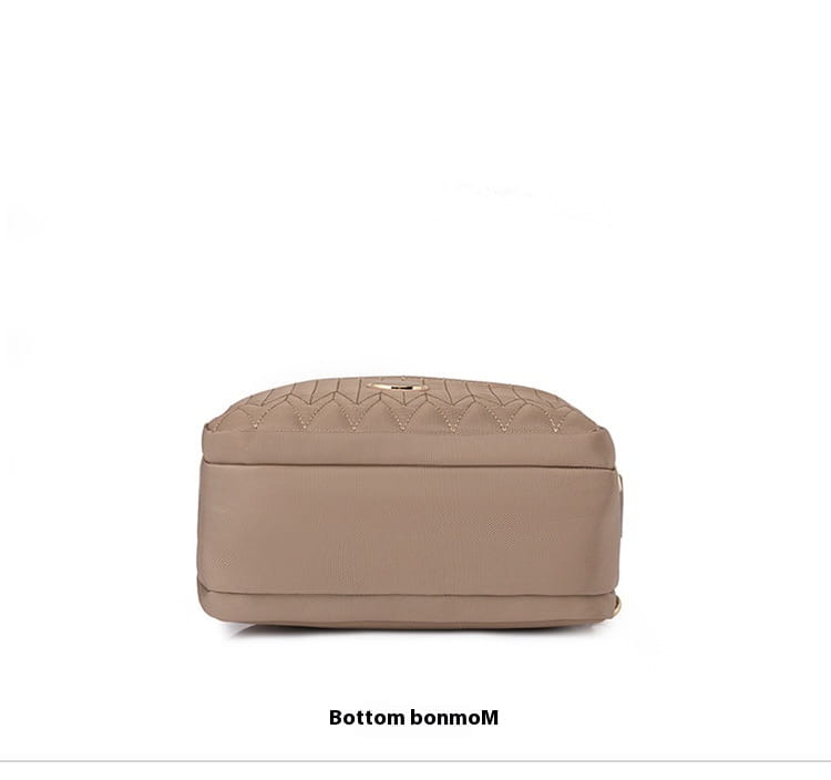 Beige quilted crossbody bag with gold hardware and strap featuring a subtle metallic logo on the front.