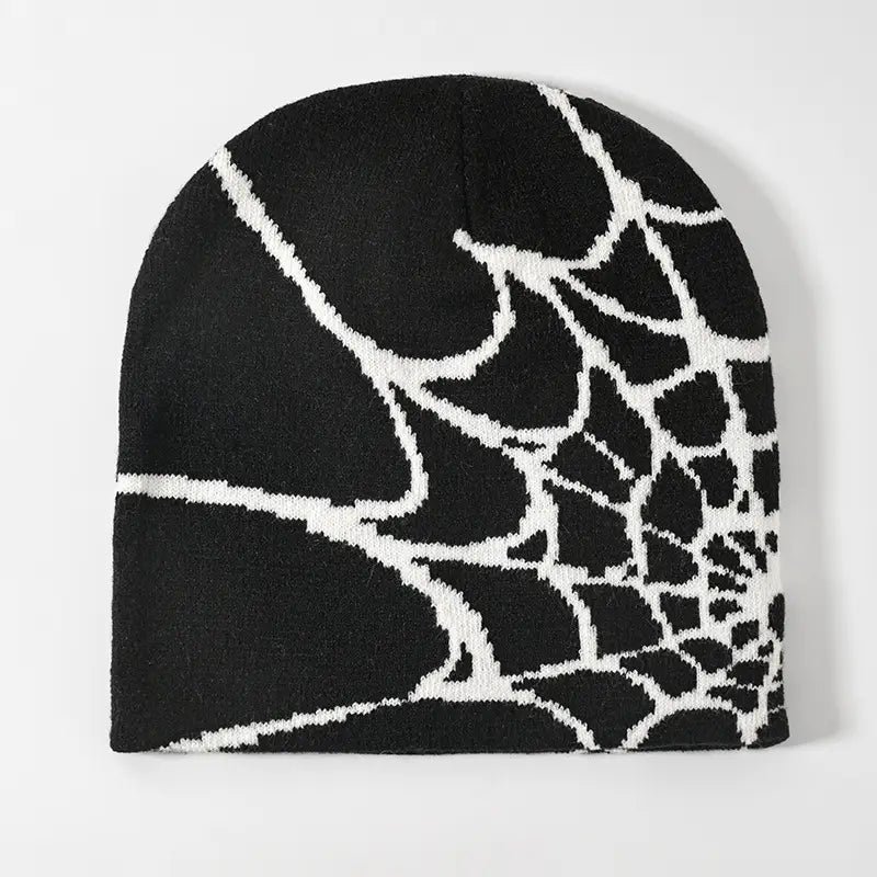 Black knit beanie featuring a bold white spiderweb pattern designed as a winter hat.