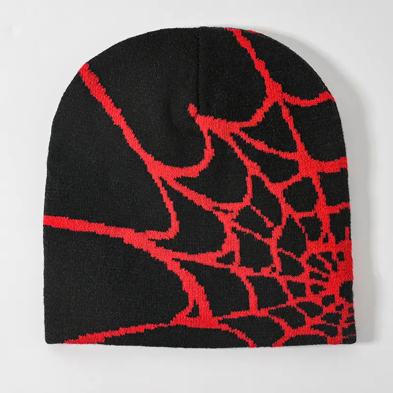 Black knit beanie featuring a bold red spiderweb pattern designed for winter wear.