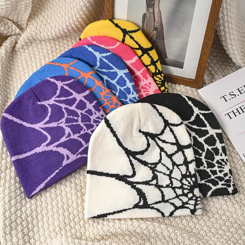 A collection of vibrant knitted spiderweb knit beanie winter hats featuring distinct spiderweb patterns.