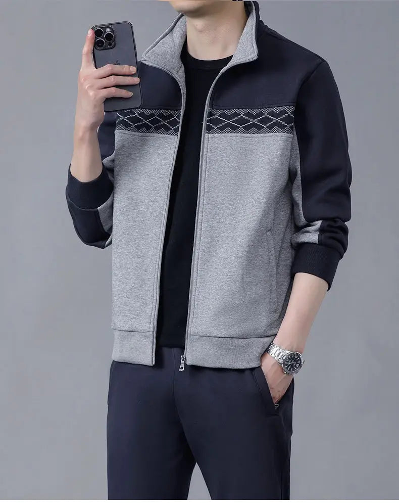 A stylish two-tone men’s geometric tracksuit spring casual athletic set featuring a heather gray and black zip-up jacket with a geometric patterned panel across the chest.