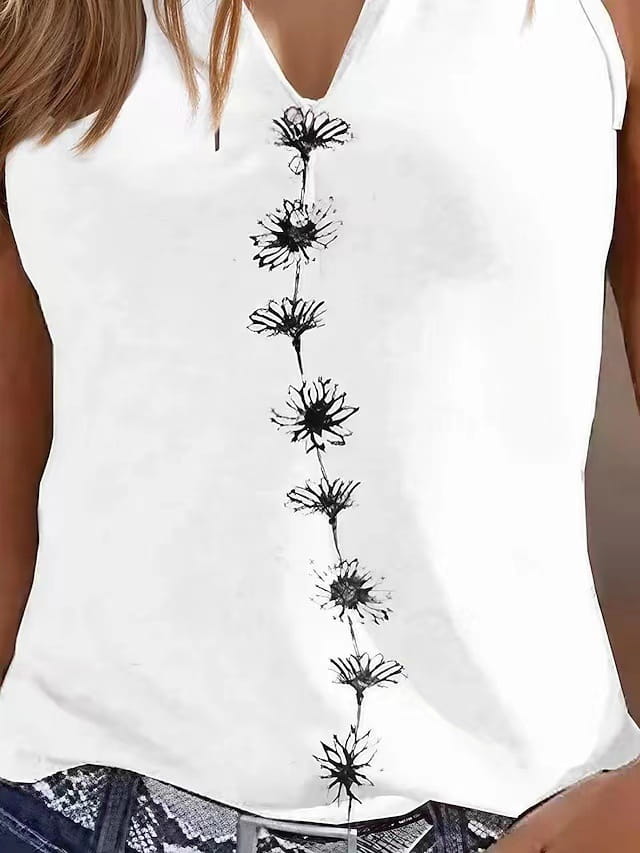 White sleeveless women’s v-neck top featuring a vertical row of black dandelion-like floral embroidery down the center.