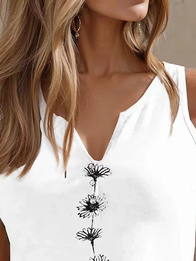 White sleeveless top with black floral embroidery down the front featuring a v-neck design for women
