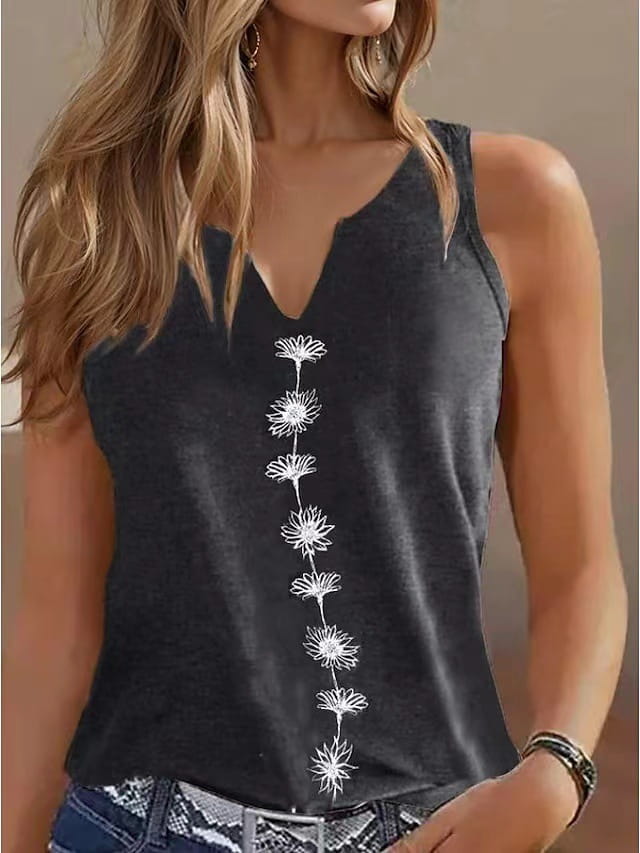 Women’s v-neck sleeveless black top with white embroidered daisy pattern running down the center front.