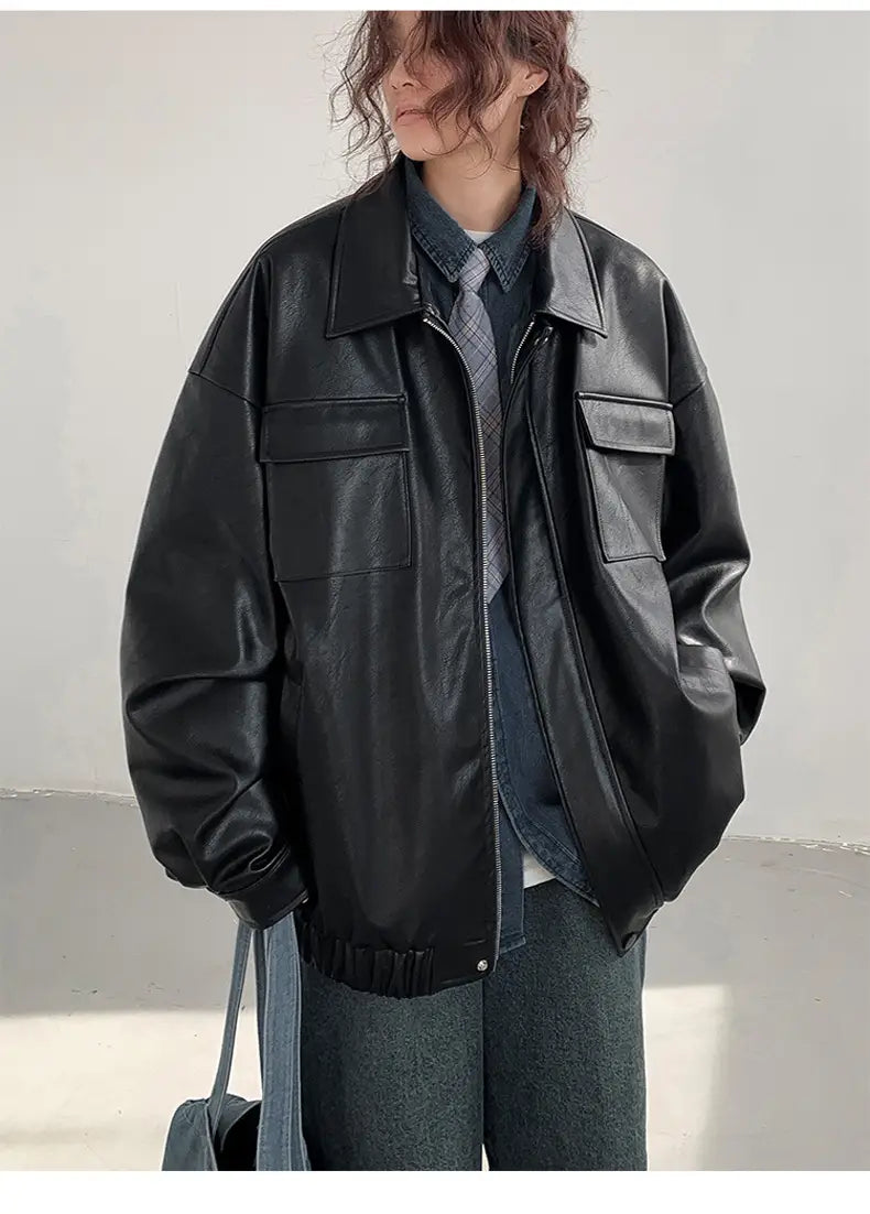 Black loose leather jacket with a relaxed fit, made of faux leather, featuring two front flap pockets and ribbed cuffs, suitable for casual spring and autumn wear.