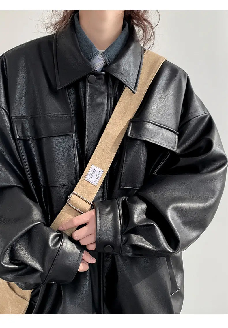 Black faux leather loose leather jacket with structured collar and flap pockets for casual spring and autumn wear.