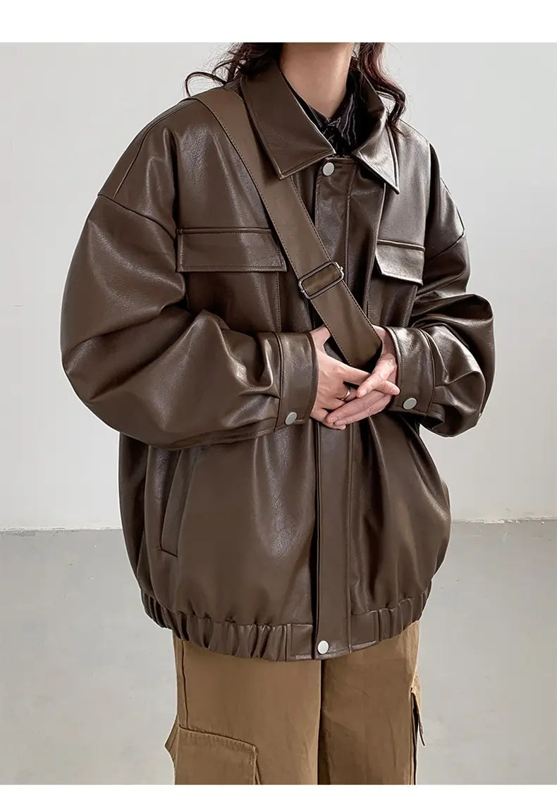 Brown faux leather loose bomber jacket with flap pockets and a drawstring waist designed for casual spring and autumn wear.