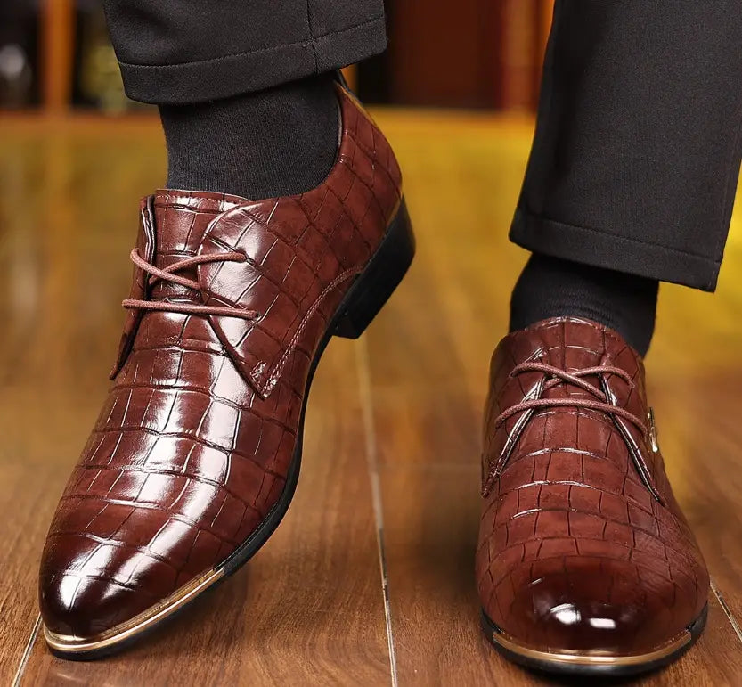 Men’s pointed toe formal leather business shoes in brown crocodile pattern with metallic toe cap and silver logo accent