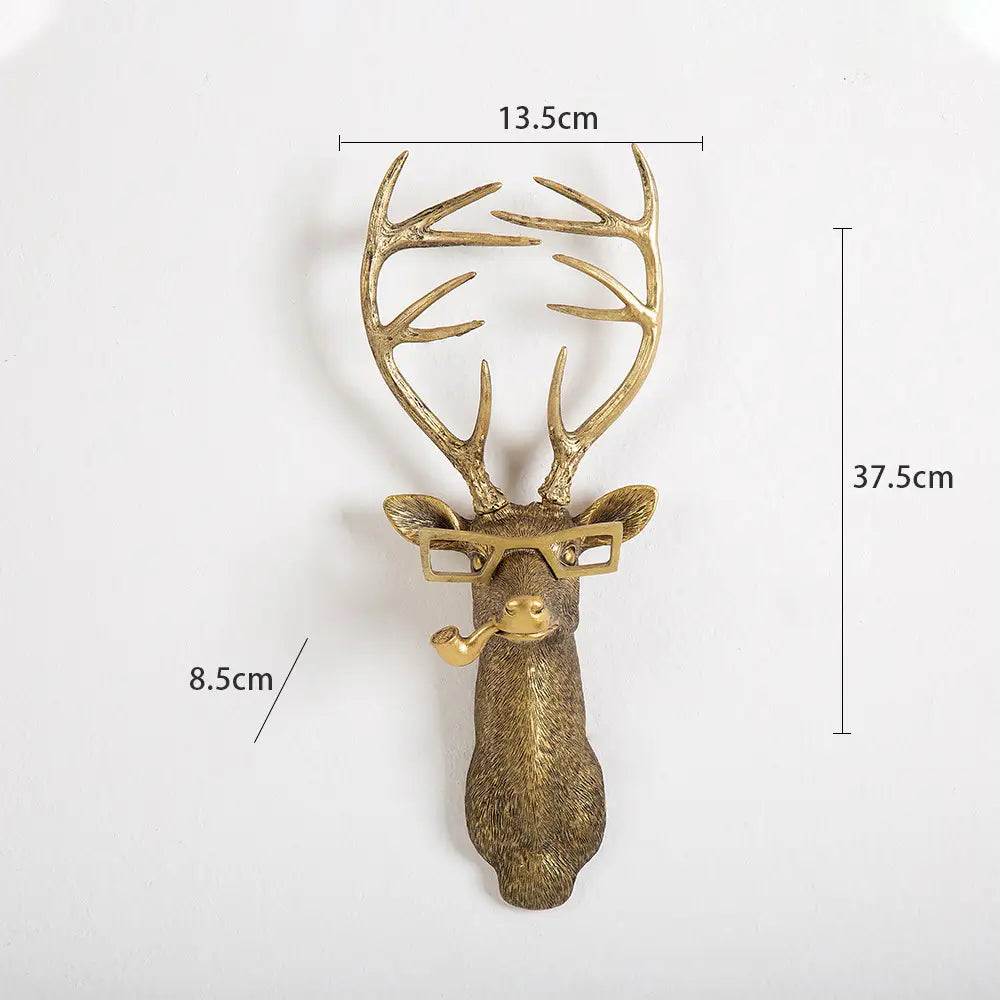 Golden brass deer head wall decor made of resin with antlers, glasses, and a pipe for stylish interior decoration.