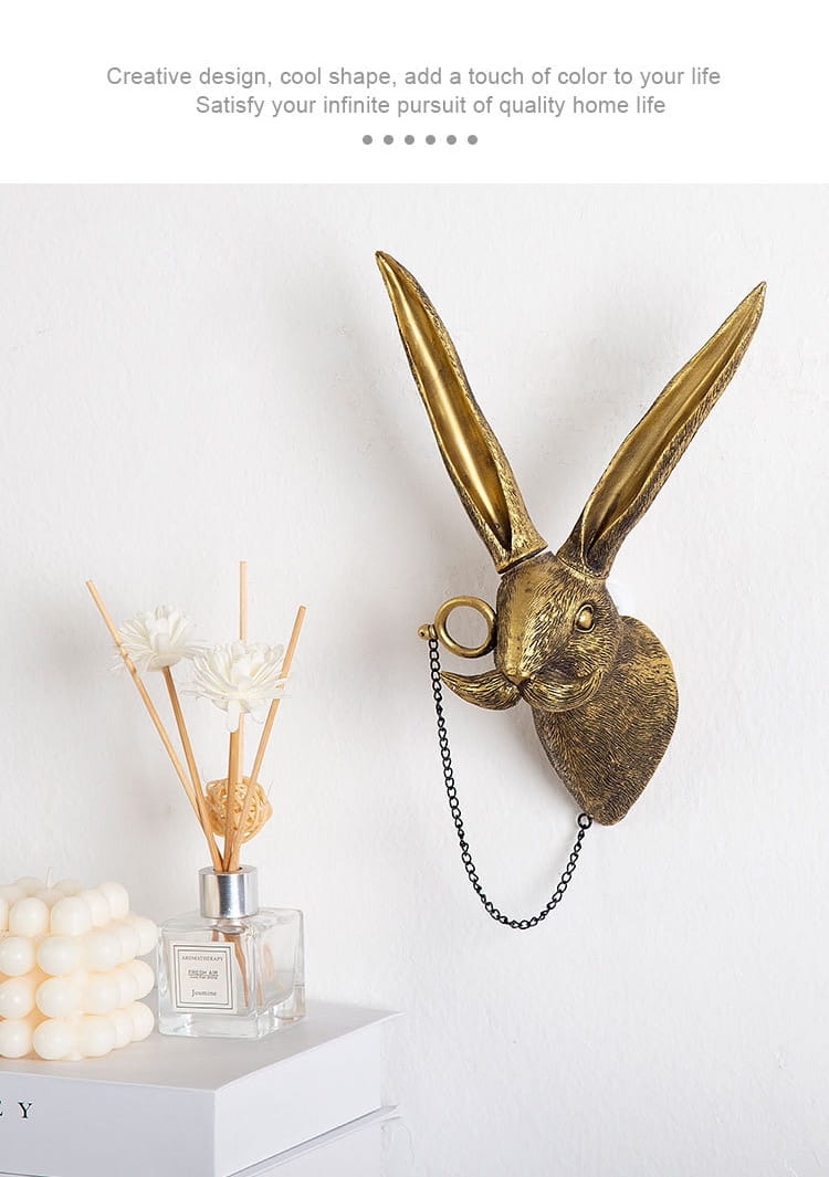 golden brass rabbit head wall decor with long ears and a dangling chain made from brass resin figurines with glasses.
