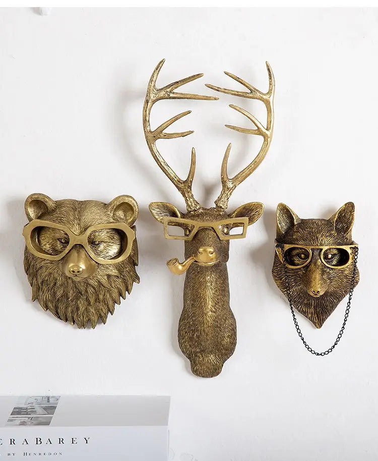 Gold-toned resin animal wall decor featuring bear deer and fox head figurines with glasses for brass resin wall decoration.