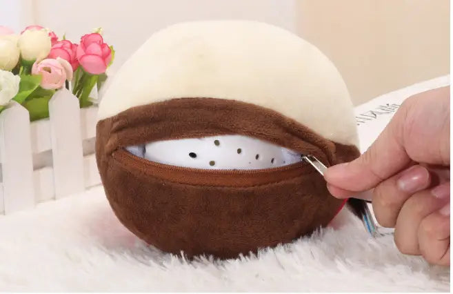 brown and cream plush coconut-shaped hand warmer with zipper opening revealing white interior from plush jumping ball interactive talking bunny toy collection