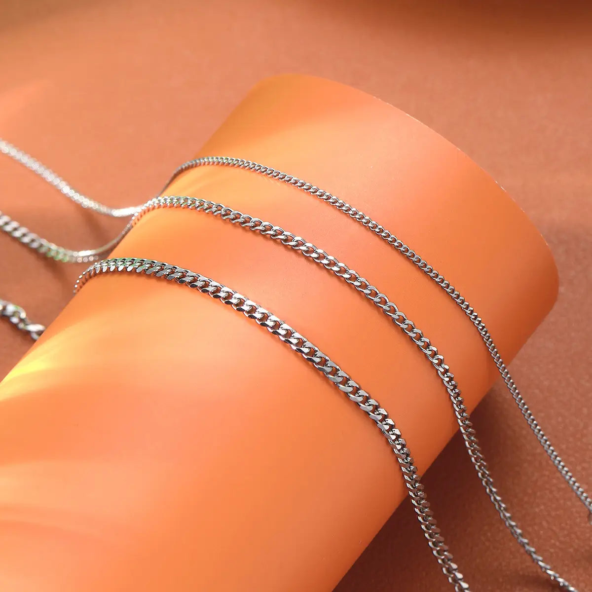 Silver-toned curb chain necklace featuring a sleek interlocking link design from the unisex silver layered Cuban and Figaro link bracelet set.