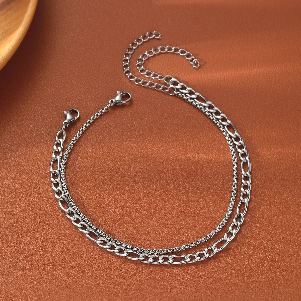 Silver-toned double-layer chain anklet featuring a mix of oval and fine link designs from the unisex silver layered Cuban and Figaro link bracelet set.