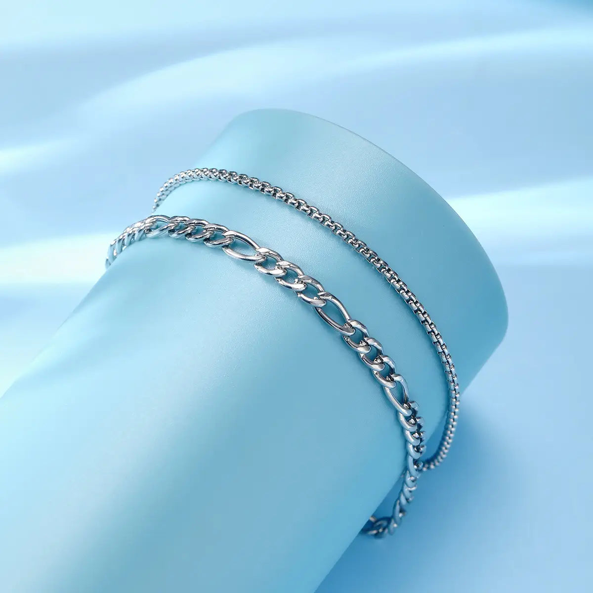 unisex silver layered cuban and figaro link bracelet set featuring a silver-toned double-layer chain bracelet with a bold figaro link and a delicate box chain design