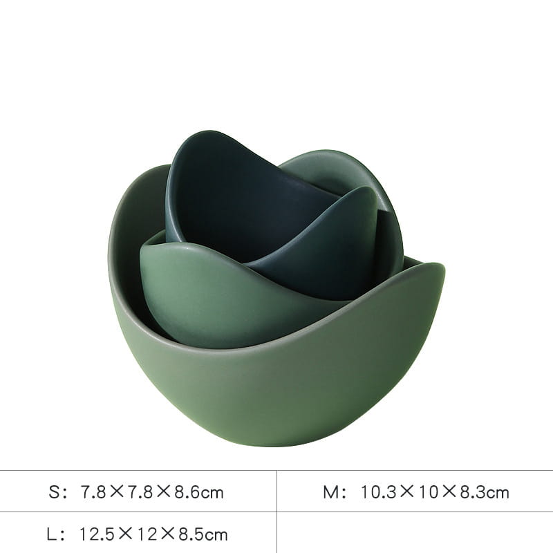Set of three nested ceramic lotus bowls in varying shades of pastel pink with smooth curved edges and a matte finish.