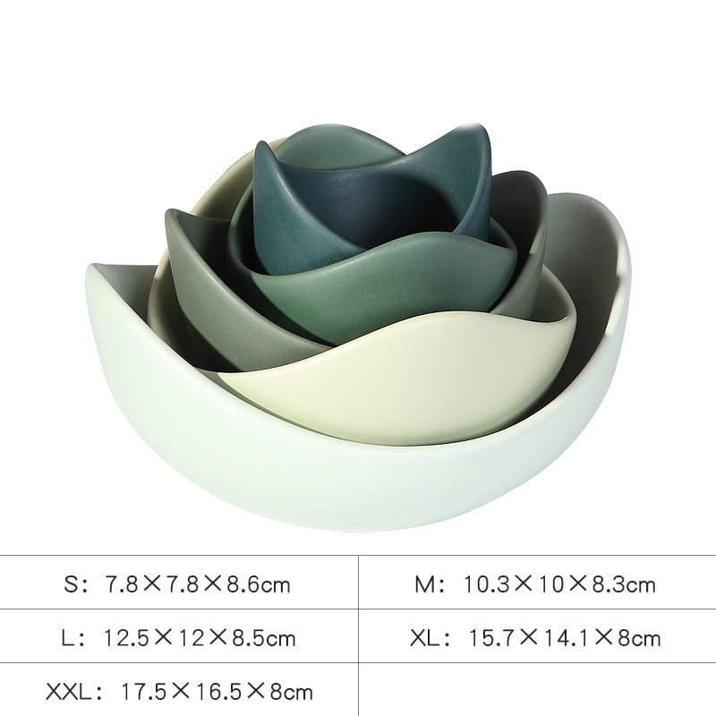 Set of five nested ceramic lotus bowls with a smooth matte finish and soft gradient hues from pale green to deep teal.