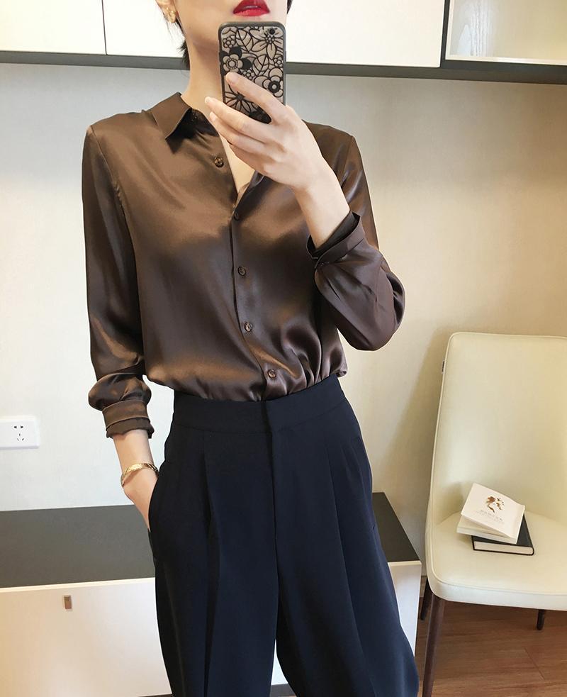 A sleek long-sleeved brown satin blouse with a classic collar and button-down front made of silk for elegant wear.