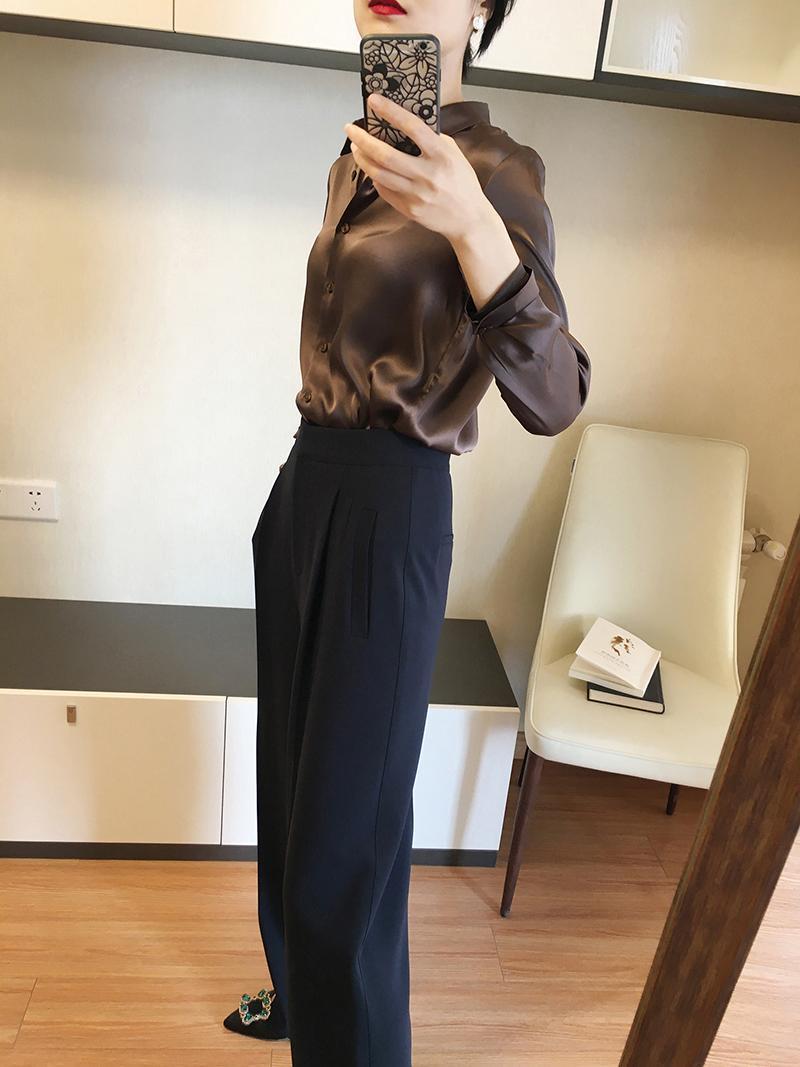 A sleek brown satin-finish long sleeve silk blouse with a classic collar and button-up front.