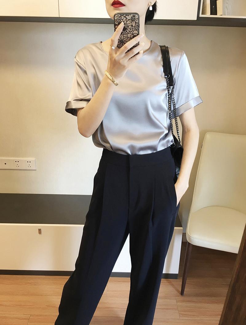 Silver satin short-sleeved top with rolled cuffs made of silk, complementing an elegant long sleeve satin button down blouse collection.