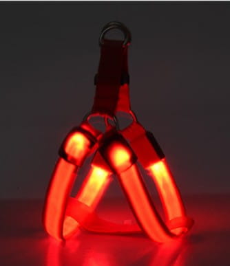 Red led light up dog harness with glowing reflective red straps and a metal d-ring attachment for secure pet chest support.