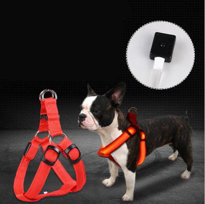 Red reflective dog harness with black buckles and built-in led light attachment for glowing safety in low light conditions.