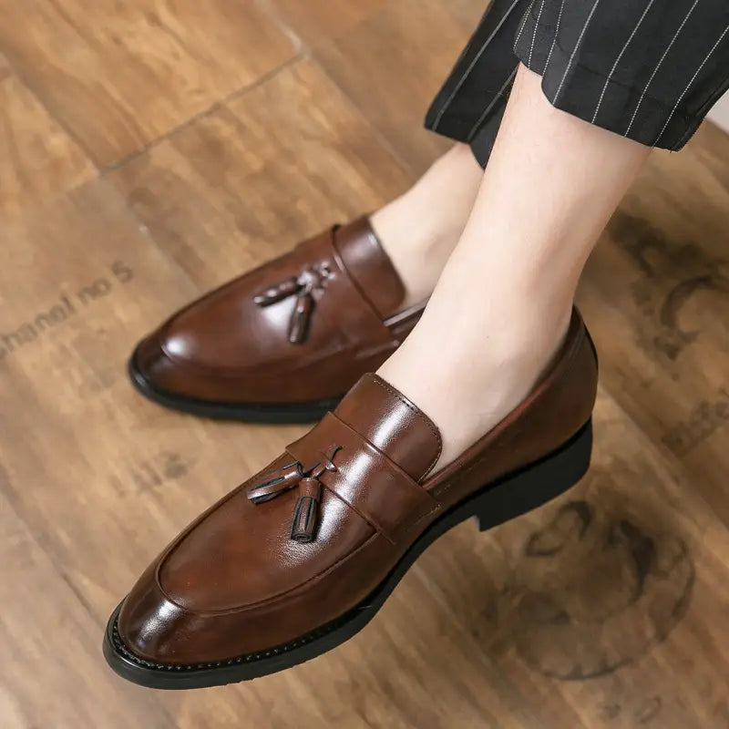 Men tassel loafers classic leather dress shoes in brown with a polished finish and black rubber soles.