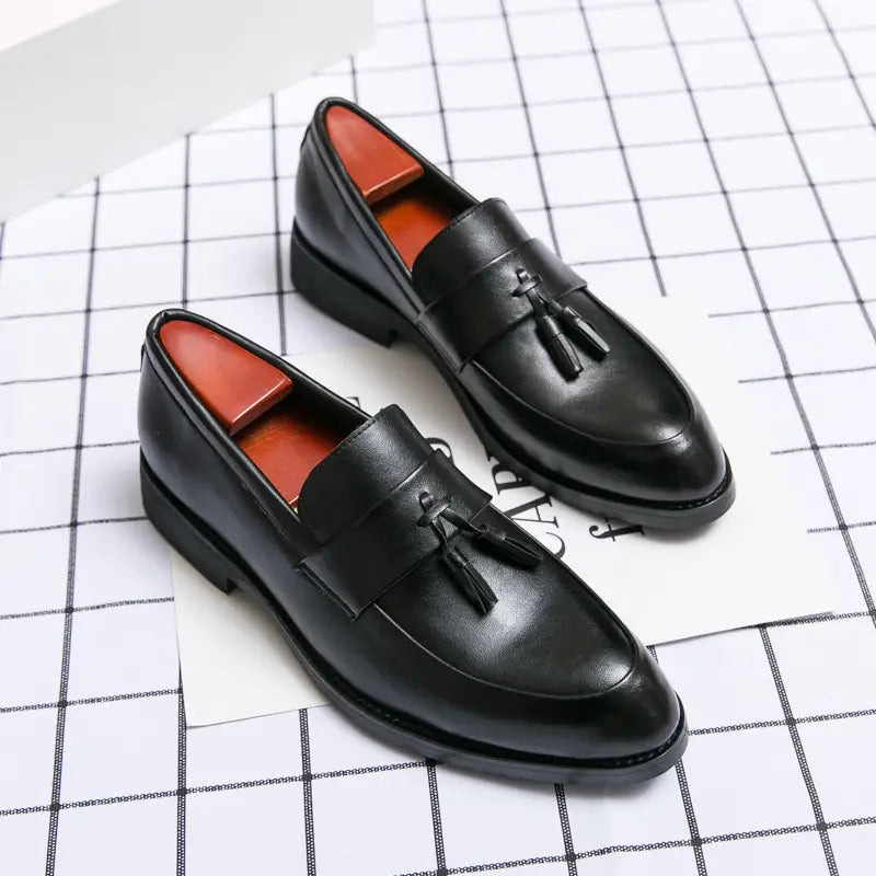 Men tassel loafers classic leather dress shoes in black with polished finish and contrasting orange interior lining.