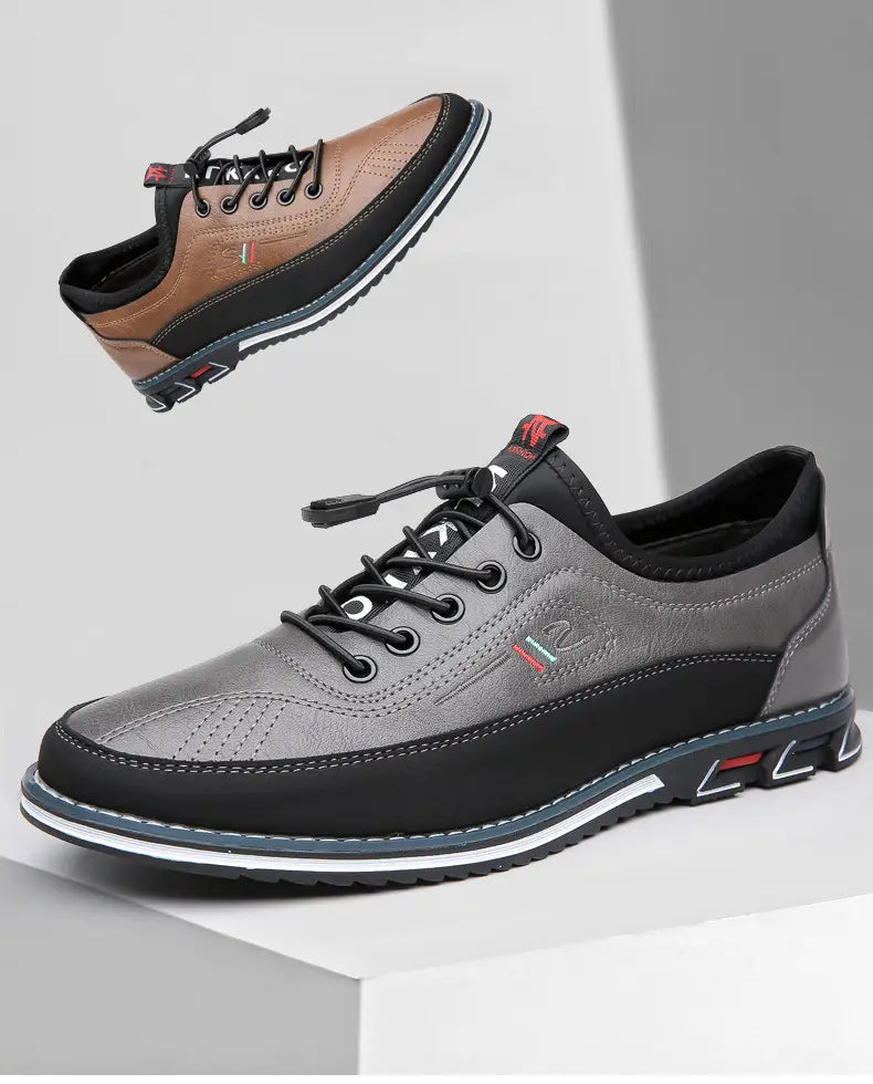 Chaussures de sport imperméables pour homme en cuir véritable gris et noir, avec design à lacets en cuir, dessus texturé, coutures contrastées et semelle en caoutchouc présentant des détails d’accent rouges.