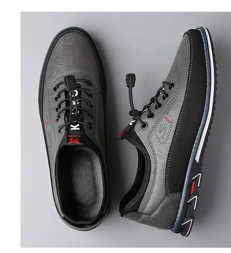 Chaussures de sport imperméables pour homme en cuir véritable gris et noir, avec design décontracté à lacets, dessus texturé, panneaux latéraux contrastés et semelle en caoutchouc à bandes blanches.
