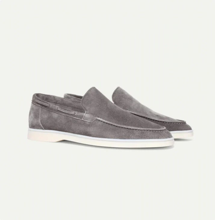 Gray suede men’s matte slip on loafers with a white rubber sole.
