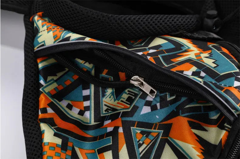 A vibrant geometric-patterned pet carrier sling bag for small dogs and cats featuring bold orange teal and black abstract designs on fabric.
