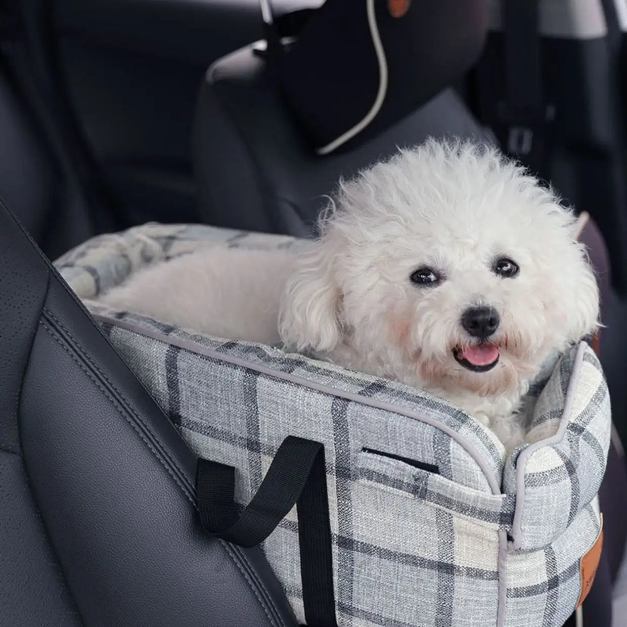 A cozy gray and white plaid fabric breathable pet carrier bag with black straps designed for comfortable travel with dogs.