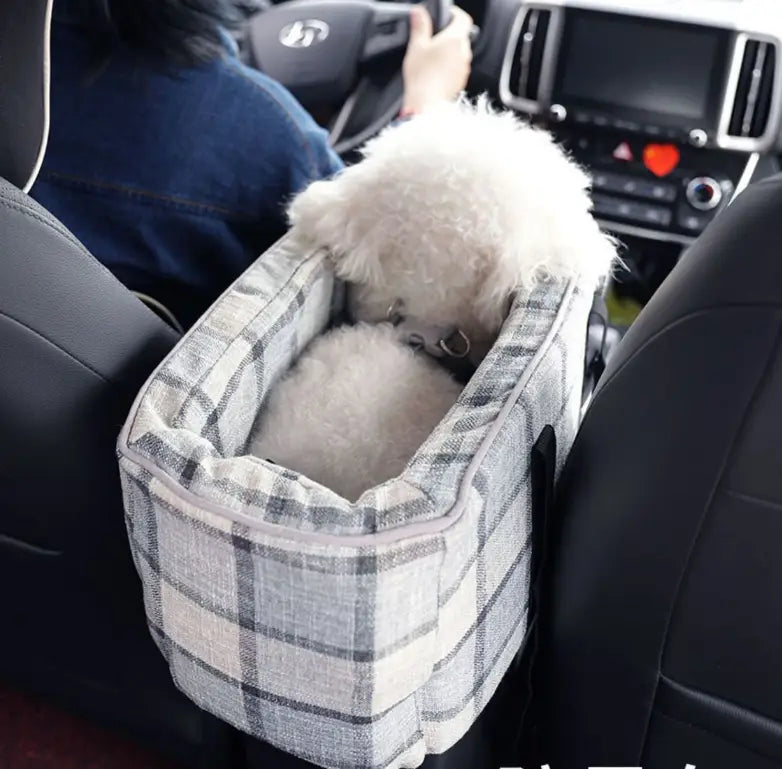 Gray and white plaid breathable fabric pet carrier bag with a fluffy white dog inside designed for travel and use as a dog purse.
