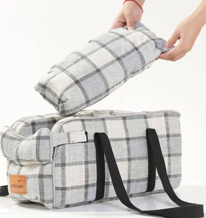 Gray and white plaid fabric pet carrier bag with breathable material and black straps for travel use.