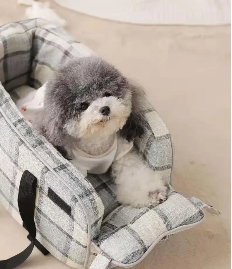Gray and white plaid breathable fabric pet carrier bag with black straps designed for travel and use as a dog purse